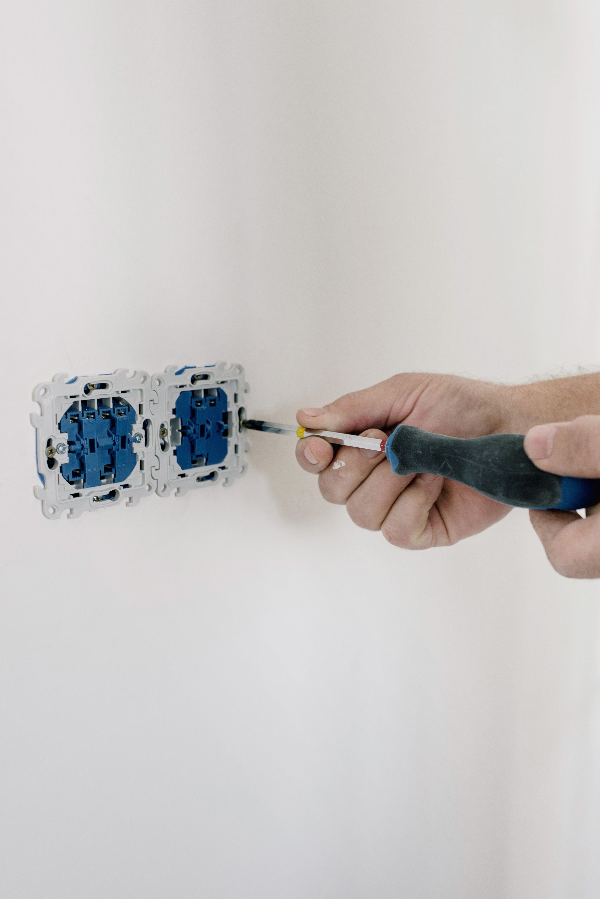 Professional electrician working on electrical panel
